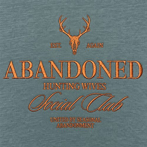 Close-up of copper brown Abandoned Hunting Wives Social Club embroidery on Blue Spruce sweatshirt