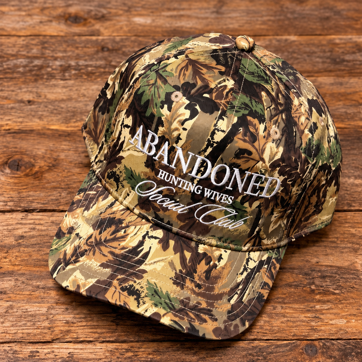 OTTO camo hat embroidered with Abandoned Hunting Wives Social Club in white stitching