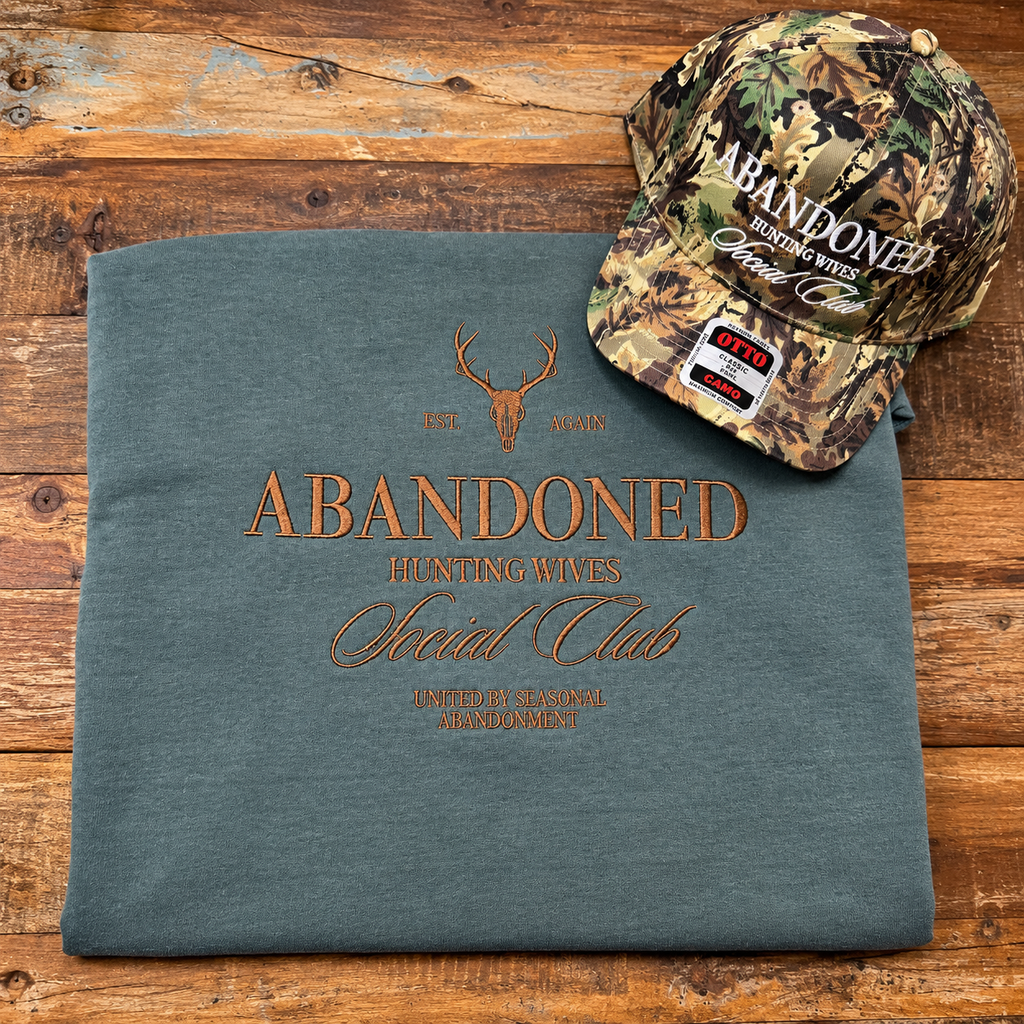 Blue Spruce embroidered Hunting Wives sweatshirt styled with a camo hat, hat sold separately